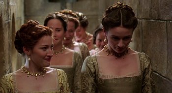 Movie still from “Elizabeth” (1998), directed by Shekhar Kapur – A group of women in medieval dress standing next to each other; Medium shot, Over the shoulder angle