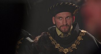 Movie still from “Elizabeth” (1998), directed by Shekhar Kapur – A person wearing a hat; Close Up shot, Over the shoulder angle