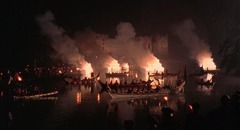 Movie still from “Elizabeth” (1998), directed by Shekhar Kapur – A group of people on a boat in the middle of the night; Extreme Wide shot, High angle