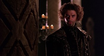 Movie still from “Elizabeth” (1998), directed by Shekhar Kapur – A person wearing a leather jacket; Close Up shot, Over the shoulder angle