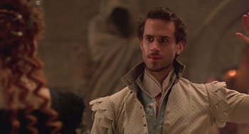 Movie still from “Elizabeth” (1998), directed by Shekhar Kapur – A man wearing a white shirt and a brown jacket; Close Up shot, Over the shoulder angle