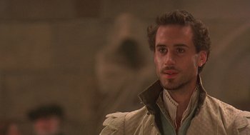 Movie still from “Elizabeth” (1998), directed by Shekhar Kapur – A person wearing a jacket; Close Up shot, Over the shoulder angle