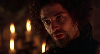 Movie still from “Elizabeth” (1998), directed by Shekhar Kapur – A person with a beard looking at the camera; Close Up shot, Low angle
