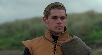 Movie still from “Elizabeth” (1998), directed by Shekhar Kapur – A man wearing a hat and a leather vest; Close Up shot, Over the shoulder angle