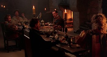 Movie still from “Elizabeth” (1998), directed by Shekhar Kapur – A group of people sitting at a table with food on it; Wide shot, High angle