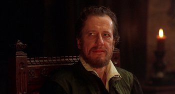 Movie still from “Elizabeth” (1998), directed by Shekhar Kapur – A person sitting in a chair; Close Up shot, Over the shoulder angle