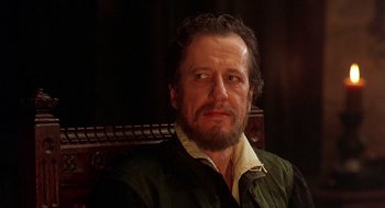 Movie still from “Elizabeth” (1998), directed by Shekhar Kapur – A person sitting on a chair; Close Up shot, Over the shoulder angle