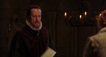 Movie still from “Elizabeth” (1998), directed by Shekhar Kapur – A man with a book in his hands; Close Up shot, Over the shoulder angle