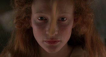 Movie still from “Elizabeth” (1998), directed by Shekhar Kapur – A young girl's face with a yellow streak coming out of her nose; Extreme Close Up shot, Overhead angle