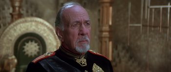 Movie still from “Dune” (1984), directed by David Lynch – An older man in a military uniform looking at the camera; Close Up shot, Low angle