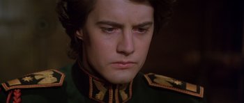 Movie still from “Dune” (1984), directed by David Lynch – A person wearing a military uniform; Close Up shot, Low angle