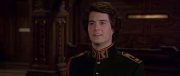 Movie still from “Dune” (1984), directed by David Lynch – A man in a military uniform is smiling for the camera; Close Up shot, Over the shoulder angle