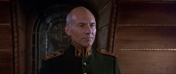 Movie still from “Dune” (1984), directed by David Lynch – A man in a military uniform looking to his left; Close Up shot, Low angle