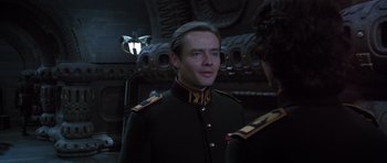 Movie still from “Dune” (1984), directed by David Lynch – A man in a military uniform standing next to another man; Close Up shot, Low angle
