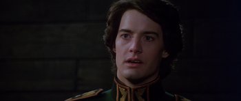 Movie still from “Dune” (1984), directed by David Lynch – A person wearing a military uniform; Close Up shot, Over the shoulder angle