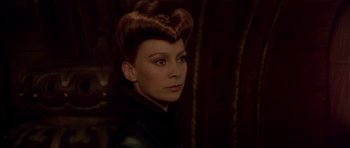 Movie still from “Dune” (1984), directed by David Lynch – A person wearing a black shirt; Close Up shot, Over the shoulder angle