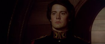 Movie still from “Dune” (1984), directed by David Lynch – A person wearing a uniform; Close Up shot, Low angle