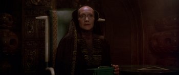 Movie still from “Dune” (1984), directed by David Lynch – An older woman in a green chair holding a green box; Close Up shot, Low angle