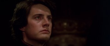 Movie still from “Dune” (1984), directed by David Lynch – A man's face in a dark room; Close Up shot, Low angle