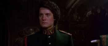 Movie still from “Dune” (1984), directed by David Lynch – A person wearing a military uniform; Close Up shot, Over the shoulder angle
