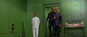 Movie still from “Dune” (1984), directed by David Lynch – A group of men standing next to each other in a room; Wide shot, Low angle