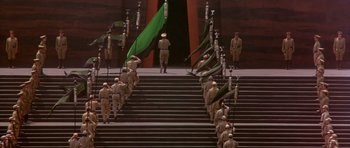 Movie still from “Dune” (1984), directed by David Lynch – A group of men standing on top of a set of stairs; Extreme Wide shot, High angle