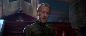 Movie still from “Dune” (1984), directed by David Lynch – A person wearing a jacket; Close Up shot, Over the shoulder angle