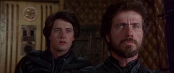 Movie still from “Dune” (1984), directed by David Lynch – Two men are looking at something in the distance; Close Up shot, Over the shoulder angle