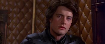 Movie still from “Dune” (1984), directed by David Lynch – A person with long hair; Close Up shot, Over the shoulder angle