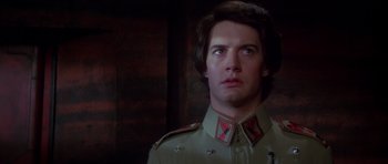 Movie still from “Dune” (1984), directed by David Lynch – A man in a uniform looking to his left; Close Up shot, Low angle