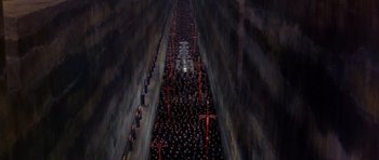 Movie still from “Dune” (1984), directed by David Lynch – A crowd of people standing in the middle of a tunnel; Extreme Wide shot, High angle