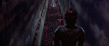 Movie still from “Dune” (1984), directed by David Lynch – A crowd of people standing in an alley; Extreme Wide shot, High angle