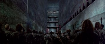 Movie still from “Dune” (1984), directed by David Lynch – A group of people standing in front of a building; Extreme Wide shot, High angle