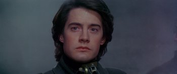 Movie still from “Dune” (1984), directed by David Lynch – A person with long hair; Close Up shot, Low angle