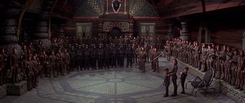 Movie still from “Dune” (1984), directed by David Lynch – A large group of people in black suits and helmets; Extreme Wide shot, High angle