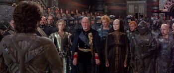 Movie still from “Dune” (1984), directed by David Lynch – A group of people standing in front of a crowd; Wide shot, Over the shoulder angle