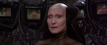 Movie still from “Dune” (1984), directed by David Lynch – An older woman with a bald head is looking at the camera; Close Up shot, Over the shoulder angle