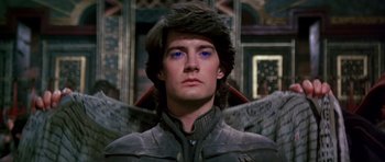 Movie still from “Dune” (1984), directed by David Lynch – A person wearing a costume; Close Up shot, Low angle
