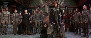 Movie still from “Dune” (1984), directed by David Lynch – A group of people standing in a room; Wide shot, Low angle