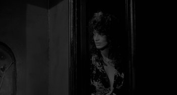 Movie still from “Eraserhead” (1977), directed by David Lynch – A black and white photo of a woman looking out of a window; Medium shot, Over the shoulder angle