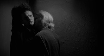 Movie still from “Eraserhead” (1977), directed by David Lynch – A man and a woman standing next to each other in front of a wall; Close Up shot, Over the shoulder angle