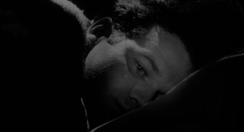 Movie still from “Eraserhead” (1977), directed by David Lynch – Black and white photograph of a man with a beard; Close Up shot, Overhead angle