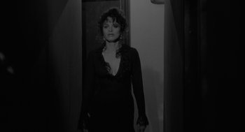 Movie still from “Eraserhead” (1977), directed by David Lynch – A black and white photo of a woman in a black dress; Medium shot, Over the shoulder angle