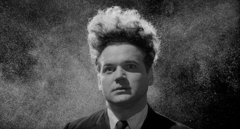 Movie still from “Eraserhead” (1977), directed by David Lynch – A black and white photo of a man with a crazy haircut; Close Up shot, Low angle