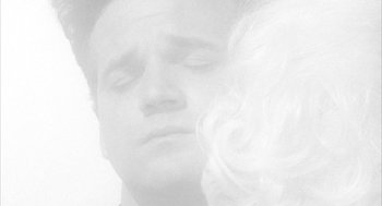 Movie still from “Eraserhead” (1977), directed by David Lynch – A man and a woman looking at each other; Close Up shot, Overhead angle