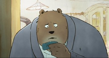 Movie still from “Ernest and Celestine: A Trip to Gibberitia” (2022), directed by Jean-Christophe Roger – A cartoon of a brown bear holding a cell phone; Close Up shot, Low angle