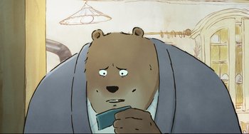 Movie still from “Ernest and Celestine: A Trip to Gibberitia” (2022), directed by Jean-Christophe Roger – A cartoon of a brown bear holding something in his mouth; Close Up shot, Low angle