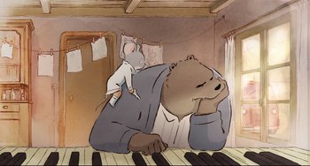 Movie still from “Ernest and Celestine: A Trip to Gibberitia” (2022), directed by Jean-Christophe Roger – A cartoon of a bear sitting on top of a keyboard; Medium shot, High angle