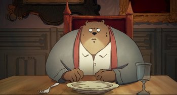 Movie still from “Ernest and Celestine: A Trip to Gibberitia” (2022), directed by Jean-Christophe Roger – An animated bear sitting at a table with a plate in front of him; Medium shot, High angle