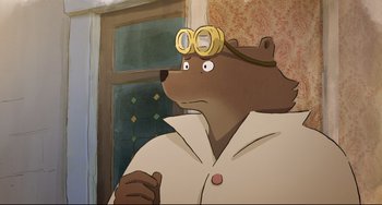 Movie still from “Ernest and Celestine: A Trip to Gibberitia” (2022), directed by Jean-Christophe Roger – A cartoon of a brown bear wearing glasses; Close Up shot, High angle